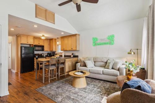 a living room with a couch and a kitchen at Newly Renovated Tremont Treasure I Cozy + Modern in Cleveland