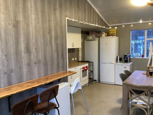 a kitchen with white appliances and a wooden counter at The Castle in Búðardalur