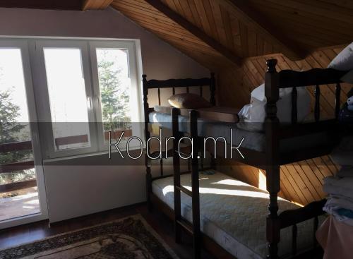 a bedroom with two bunk beds and a window at Kodra - Villa 71 in Tetovo