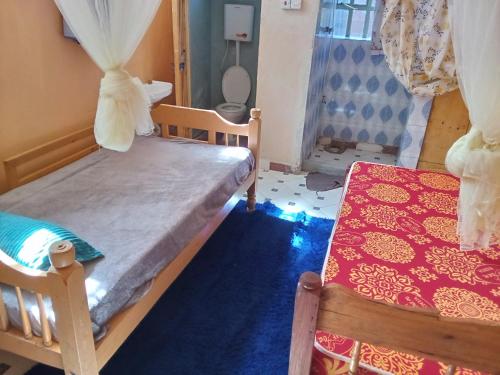 a bedroom with two bunk beds and a table at Sam & Miriam's Homestay in Nakuru