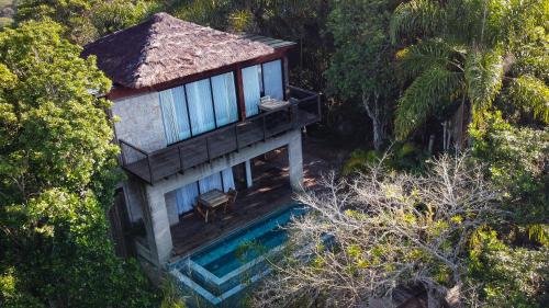 an aerial view of a house with a pool at Pousada Rosa Norte in Imbituba