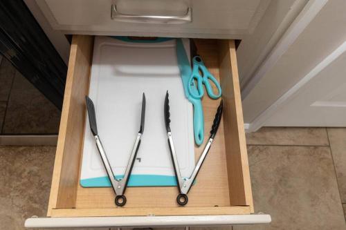 a wooden box with three pairs of scissors in it at Beach Home w Peloton & Pool & Billiards in Raleigh