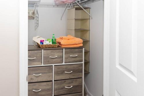 a closet with a dresser with towels on it at Beach Home w Peloton & Pool & Billiards in Raleigh