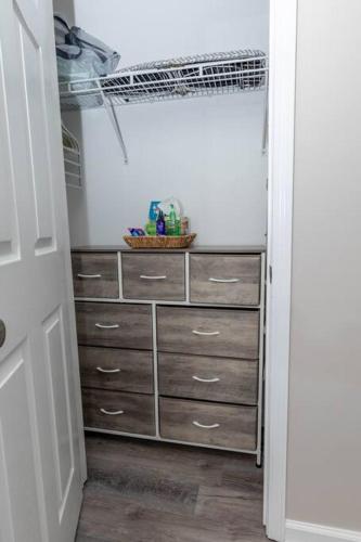 a closet with a dresser with drawers and a shelf at Beach Home w Peloton & Pool & Billiards in Raleigh