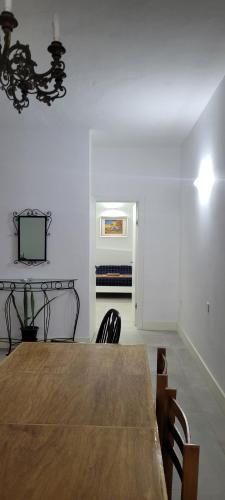 a dining room with a wooden table and chairs at Green door Valletta in Valletta