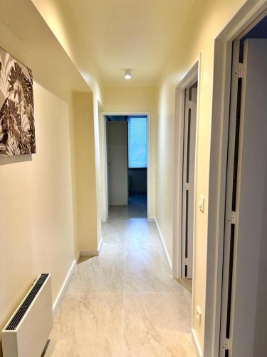 an empty hallway in a building with a view of a room at Renovated Apartment in Antwerp city center in Antwerp