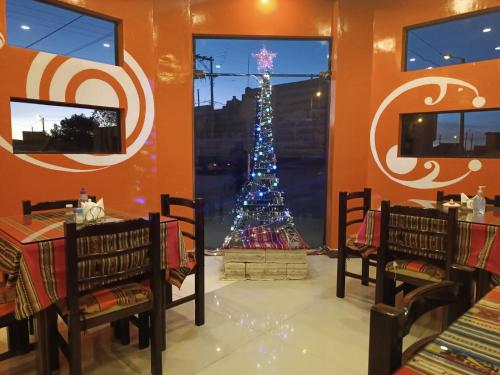 a christmas tree in the corner of a restaurant at Hotel Cristales De Sal in Uyuni
