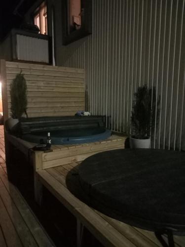 a room with a bathtub with a table and a bed at The Castle in Búðardalur