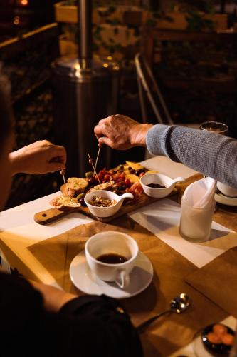 a person eating a plate of food on a table at Hotel Casa del Barranco in Cuenca