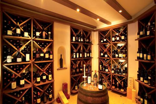 a wine cellar filled with bottles and wine glasses at Hotel Armin in Selva di Val Gardena