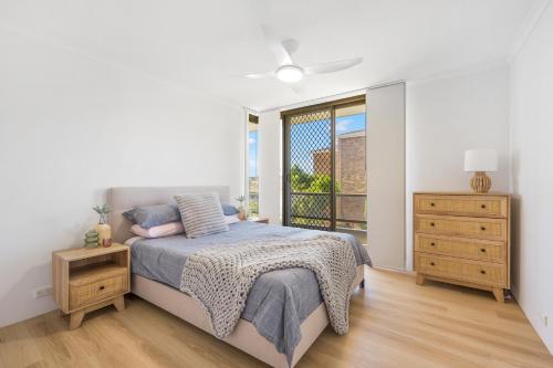 a bedroom with a bed and a window at Sundial 202 8-10 Hollingworth Street in Port Macquarie