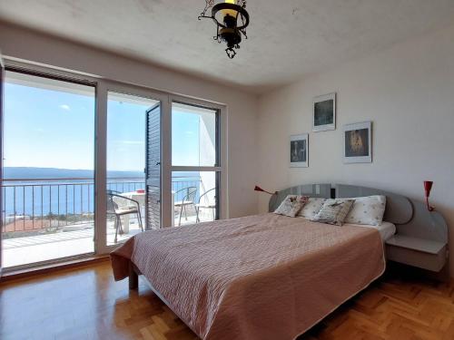 - une chambre avec un lit et un balcon dans l'établissement Apartments Dara, à Crikvenica