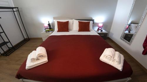 a bedroom with a large bed with towels on it at M&G holiday house in Matera