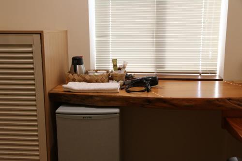 a kitchen with a counter top and a window at Romeo B&B in Taitung City