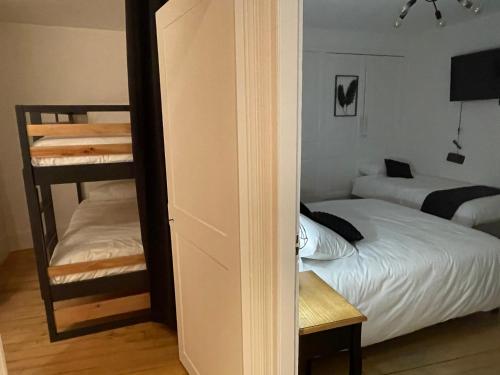 1 dormitorio con 1 cama y 1 litera en La Demeure des Hôtes 10 minutes de Disney, en Couilly-Pont-aux-Dames