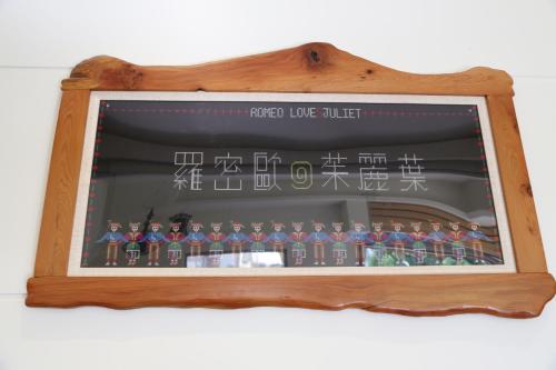 a display of toy figurines in a wooden frame at Romeo B&B in Taitung City