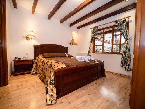 a bedroom with a leopard print bed in a room at Hotel Casa del Barranco in Cuenca