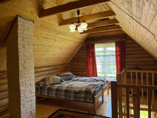 a bedroom with a bed in a log cabin at ШОВКОВА КОСИЦЯ in Rakhiv