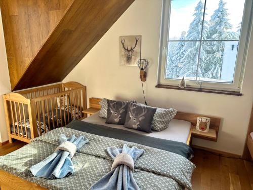 a bedroom with a bed with towels on it at Apartmán U Tří smrků in Boží Dar