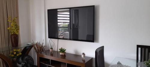 a television hanging on a wall in a room at Via Venetto FEIRINHA in Fortaleza