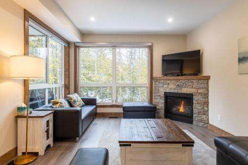 a living room with a couch and a fireplace at Polar Peak by Fernie Central Reservations in Fernie
