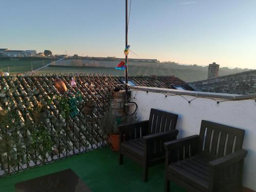 two chairs sitting on a balcony with a wall at Cal Massana in Sant Guim de la Plana