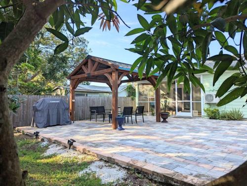 a pavilion with chairs and a table on a patio at 3Bed & 2Bath Property Couple minutes from Siesta Key Beach & Downtown Sarasota in Sarasota