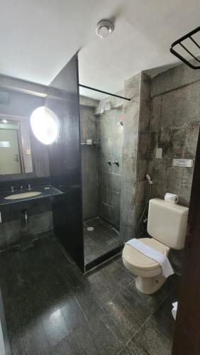 Un baño con ducha, inodoro y lavabo. en Quarto em Hotel no Bairro de Tambaú, em uma localização bem central Apto 216, en João Pessoa