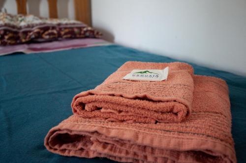 a pile of towels sitting on top of a bed at Hope del Bosque in Ushuaia