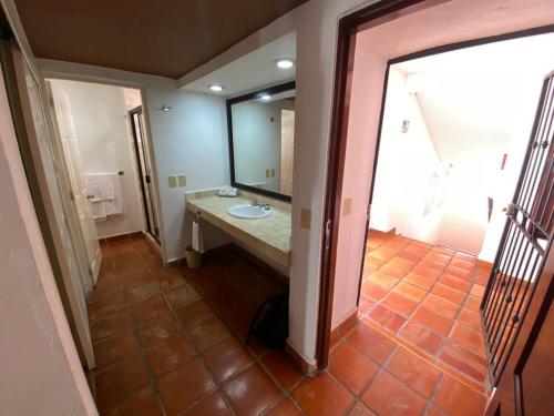 een badkamer met een wastafel en een grote spiegel bij one beach street hotel -Beach front Spacious 1BD 1BA fabulous view in Zona Romantic Puerto Vallarta in Puerto Vallarta