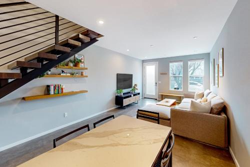 a living room with a couch and a table at Luxury Ballard Townhome in Seattle