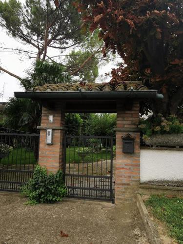 a brick gate with a roof on top of it at LA CASA DI GIM in Lugo