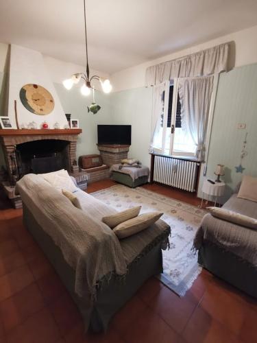 a living room with a bed and a fireplace at LA CASA DI GIM in Lugo