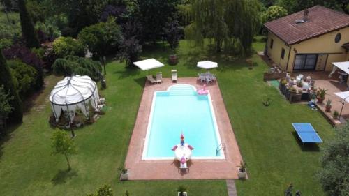 an aerial view of a pool with a space shuttle in it at Villa Fiore Luxury Pool & Garden in Pisa