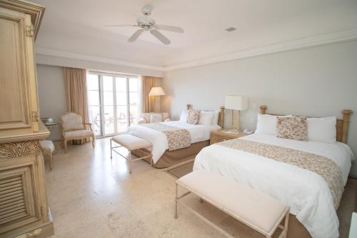a bedroom with two beds and a living room at Grand Isla Navidad Golf & Spa Resort with Marina in Barra de Navidad