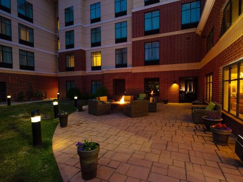 a courtyard of a building with couches and torches at Homewood Suites by Hilton Joplin in Joplin