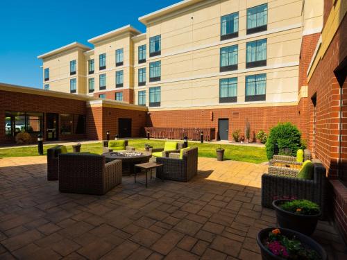 a courtyard with couches and tables in front of a building at Homewood Suites by Hilton Joplin in Joplin