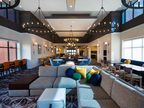 a lobby of a hotel with a couch and chairs at Homewood Suites by Hilton Joplin in Joplin
