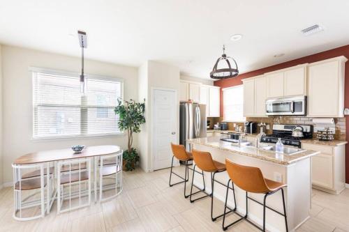 a kitchen with a table and chairs and a counter at Cozy Condo in Round Rock in Round Rock