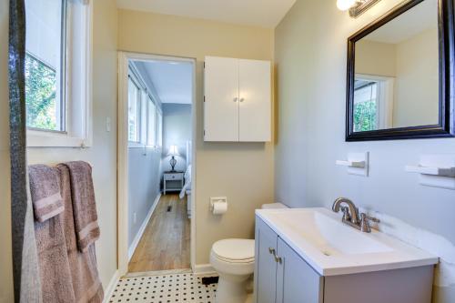 a bathroom with a sink and a toilet and a mirror at Laptop-Friendly Greensboro Home with Fireplace! in Greensboro