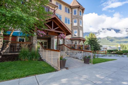 a house with a fence in front of it at Romantic Mountain Escape - Hot Tubs & Private Balcony! managed by Little Sister Getaways in Canmore