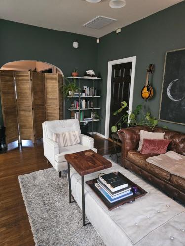 a living room with a couch and a table at Tranquility at the House of Alchemy Hollywood in Los Angeles
