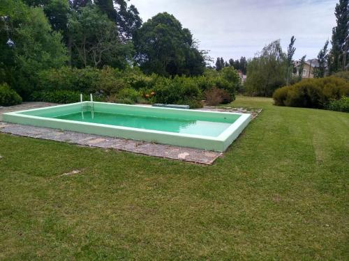 a swimming pool in the middle of a yard at Hostel Tandil in Tandil