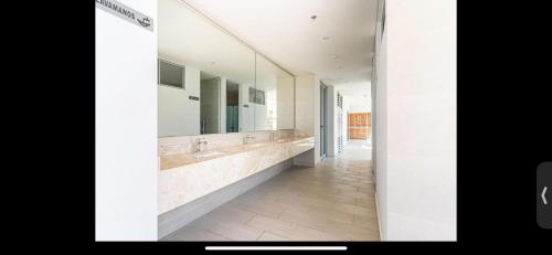 a bathroom with two sinks and a large mirror at Salguero suites resort in Gaira