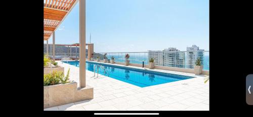 a swimming pool on the roof of a building at Salguero suites resort in Gaira