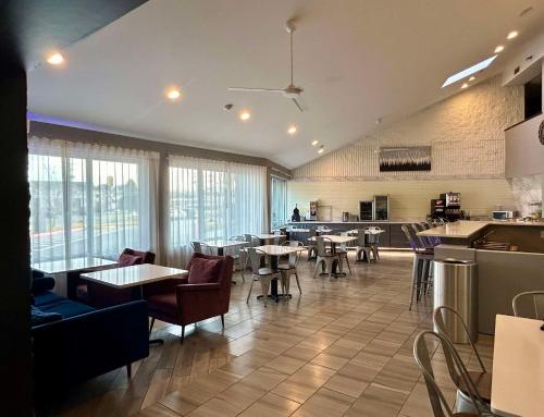 a dining room with tables and chairs and windows at Best Western Carlisle South in Carlisle