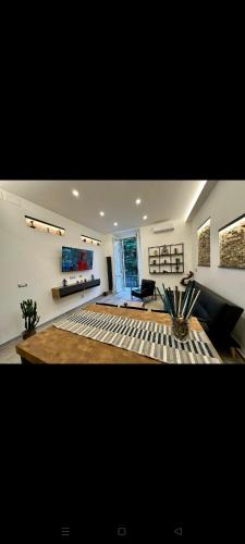 a living room with a couch and a table at Koman House in Savona