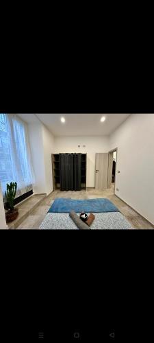 a large living room with a stage in the background at Koman House in Savona