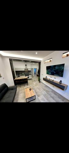 a living room with a couch and a table at Koman House in Savona