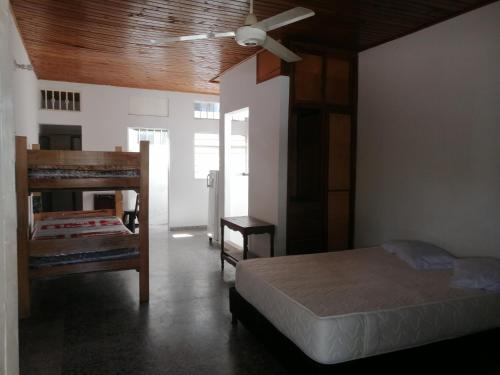 a bedroom with a bed and a ceiling fan at Casa lowcost relajación in La Dorada